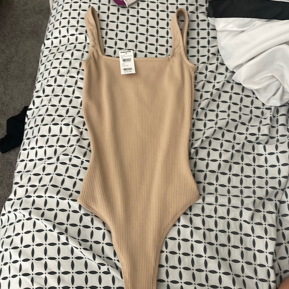 tan colored body suit